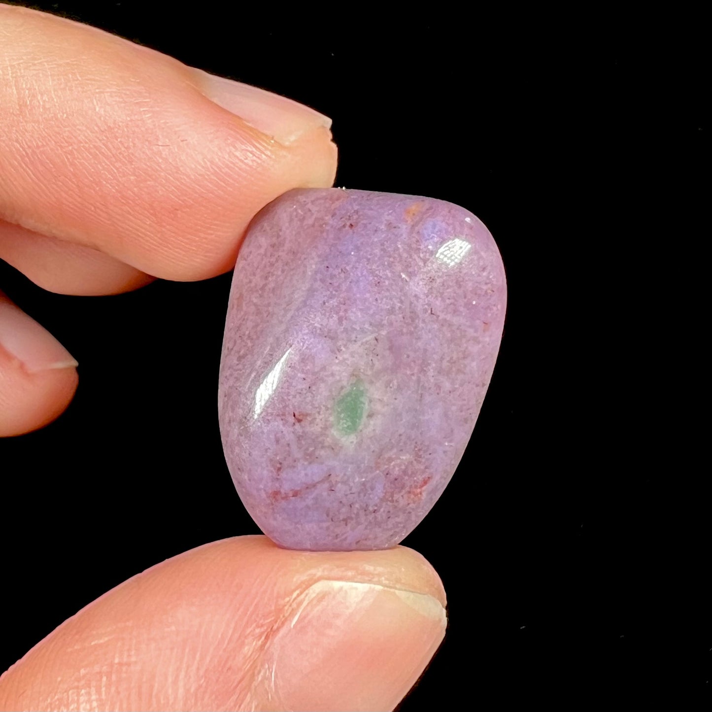 A tumbled purple turkiyenite jade stone from Borsa, Turkey.  The stone has a green jadeite inclusion.