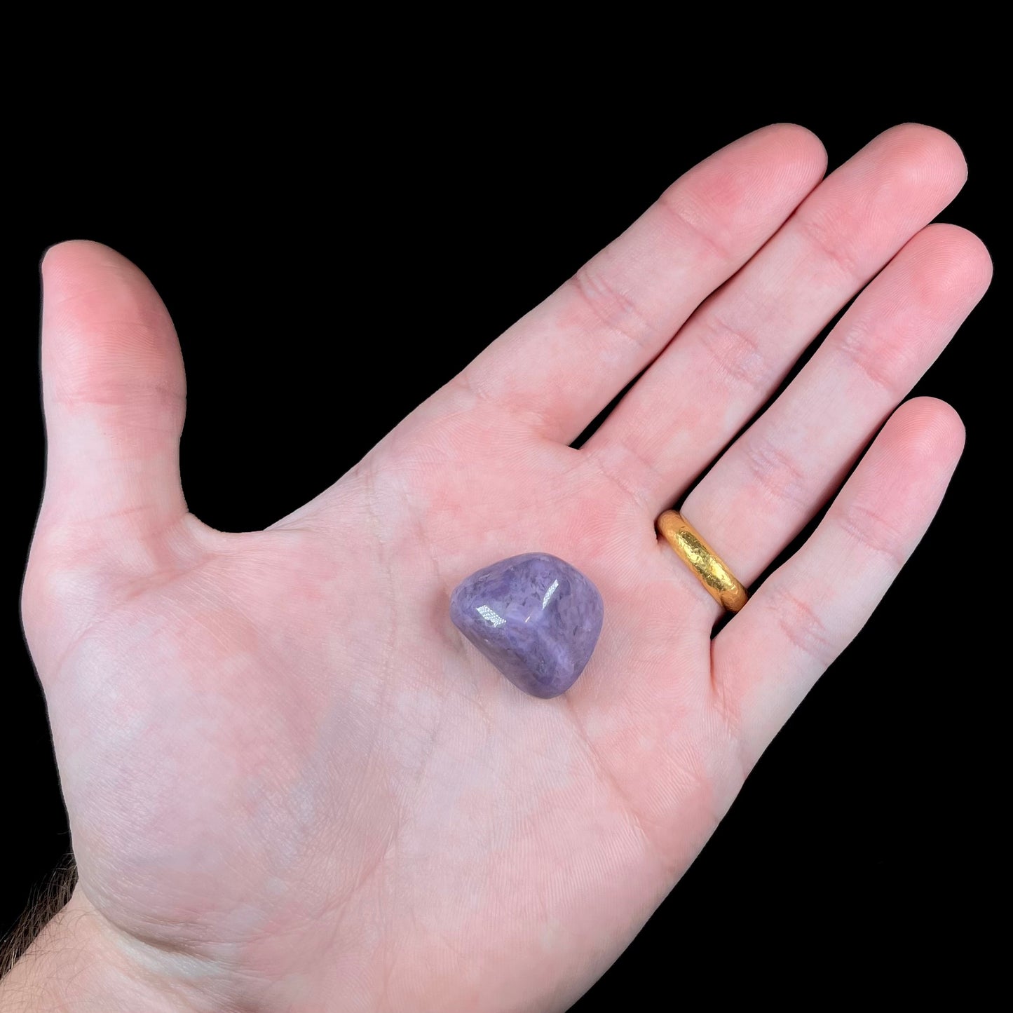 A tumbled Turkish purple jade stone, known as turkiyenite.