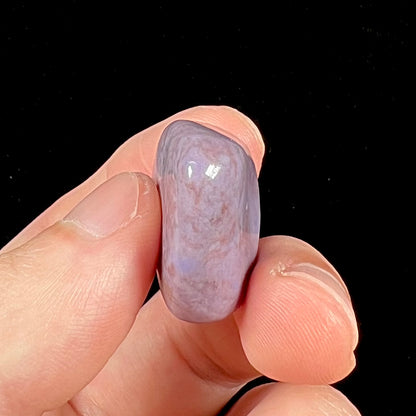 A tumbled piece of Turkish purple jade stone, also referred to as "Turkiyenite."  Material from Bursa, Turkey.