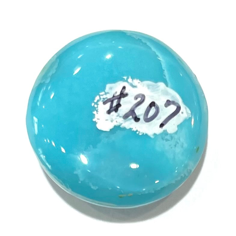 A loose, round cabochon cut turquoise stone from Sleeping Beauty Mine, Arizona.