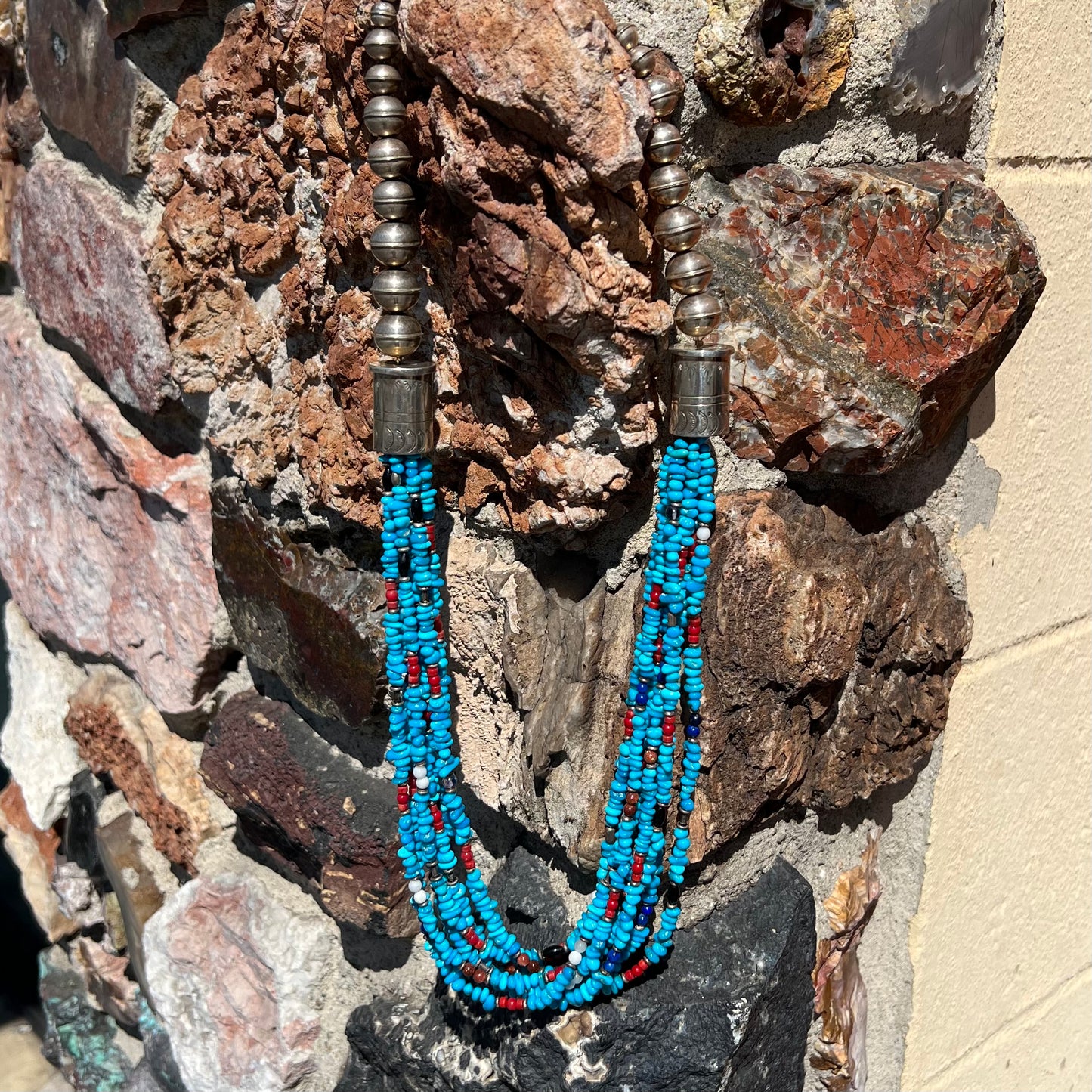 A Navajo Indian-made multistrand Sleeping Beauty turquoise bead necklace with coral, lapis lazuli, goldstone, and onyx accents.