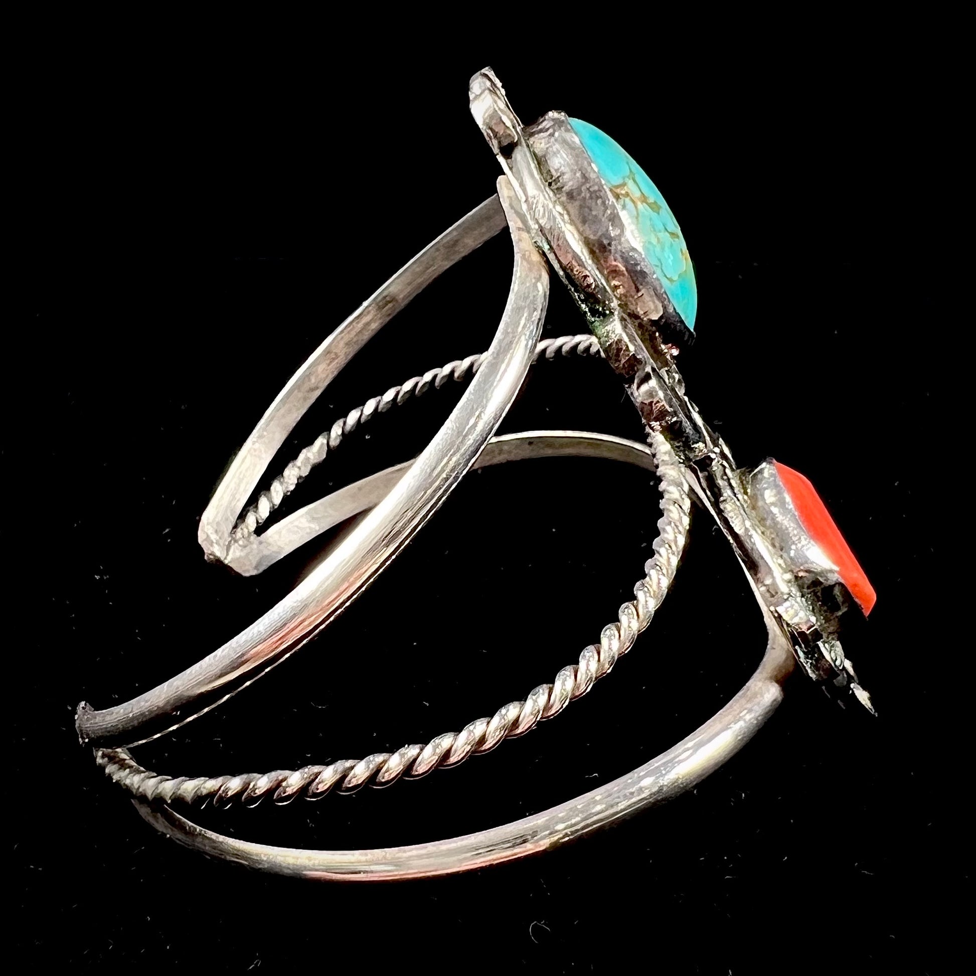 A ladies' Navajo cuff bracelet set with Royston turquoise and Mediterranean coral stones.
