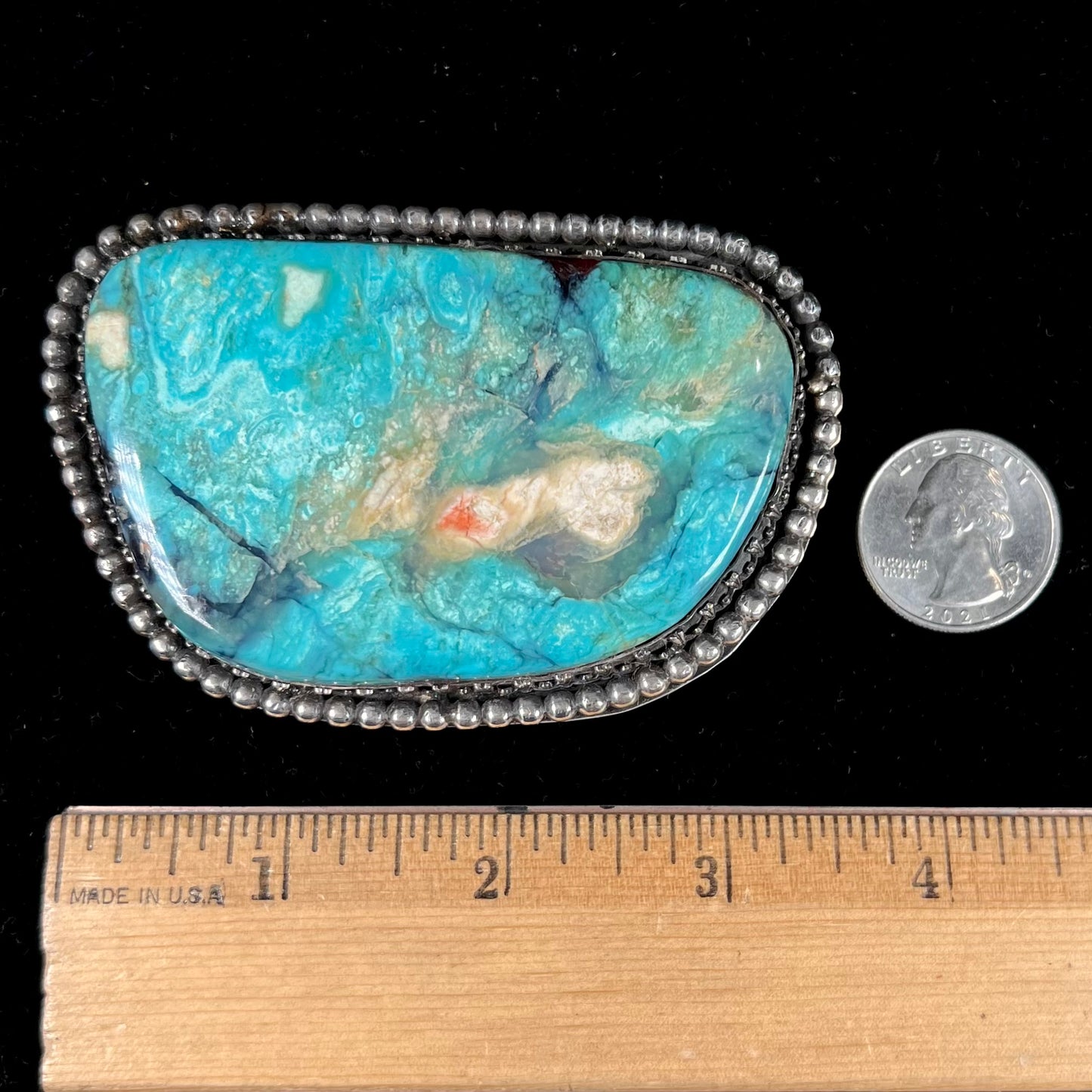 A sterling silver, unisex, Navajo style belt buckle set with a large Valley Blue turquoise stone.