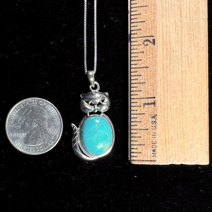 A sterling silver cat necklace set with an oval cut Sleeping Beauty turquoise stone.