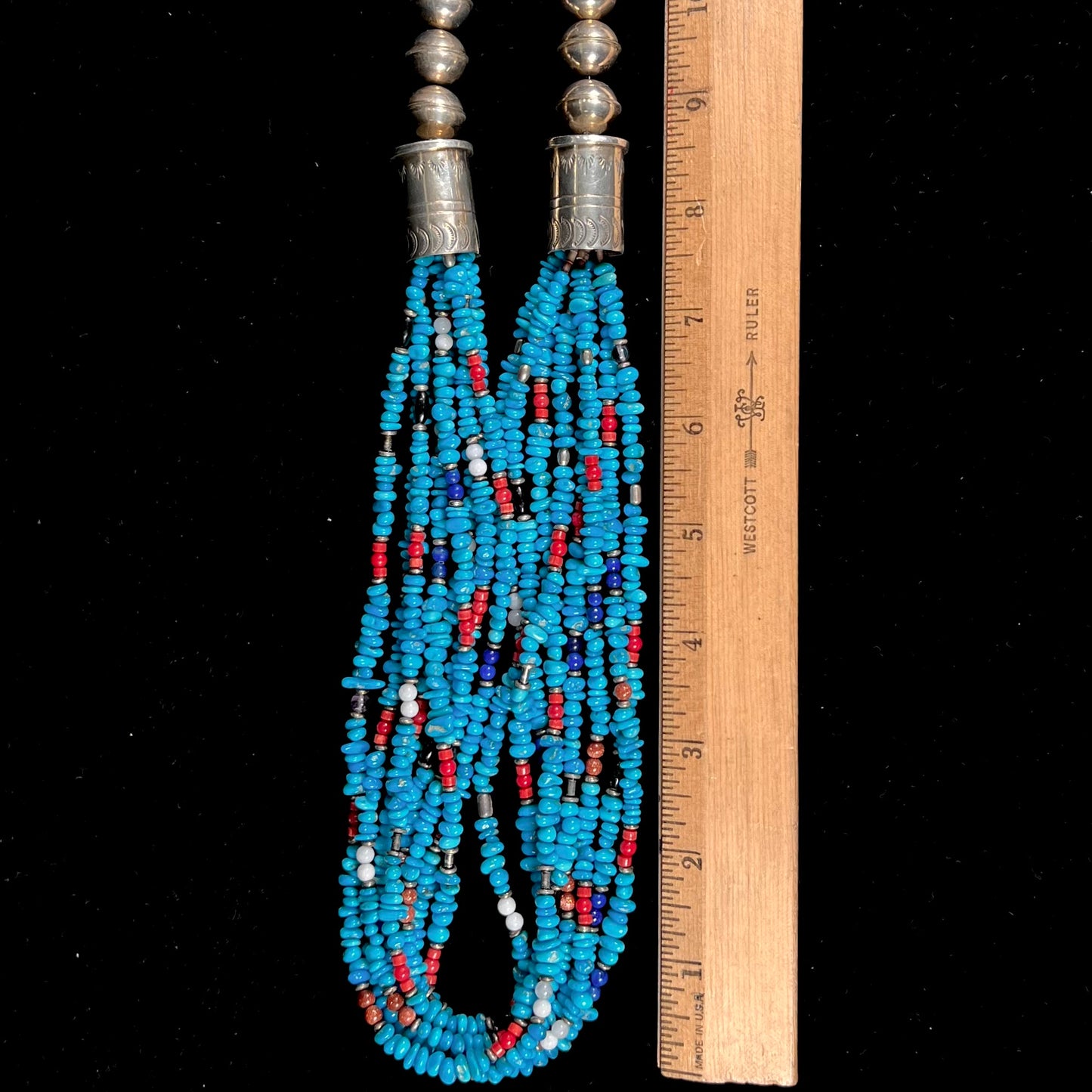 A Navajo Indian-made multistrand Sleeping Beauty turquoise bead necklace with coral, lapis lazuli, goldstone, and onyx accents.