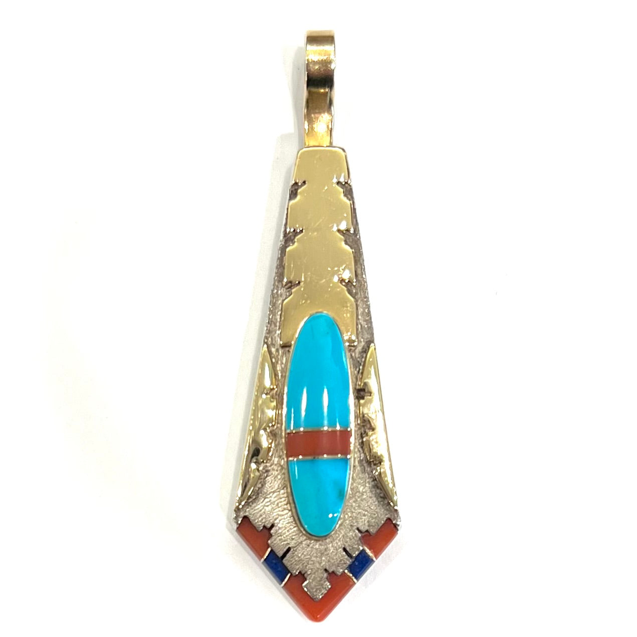 A yellow gold and sterling silver pendant inlaid with turquoise, coral, and lapis lazuli stones.  The piece is made by an unknown Native American artist and signed with the initials "LY".