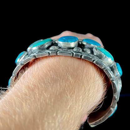 A men's sterling silver cuff bracelet bezel set with natural and synthetic turquoise stones.