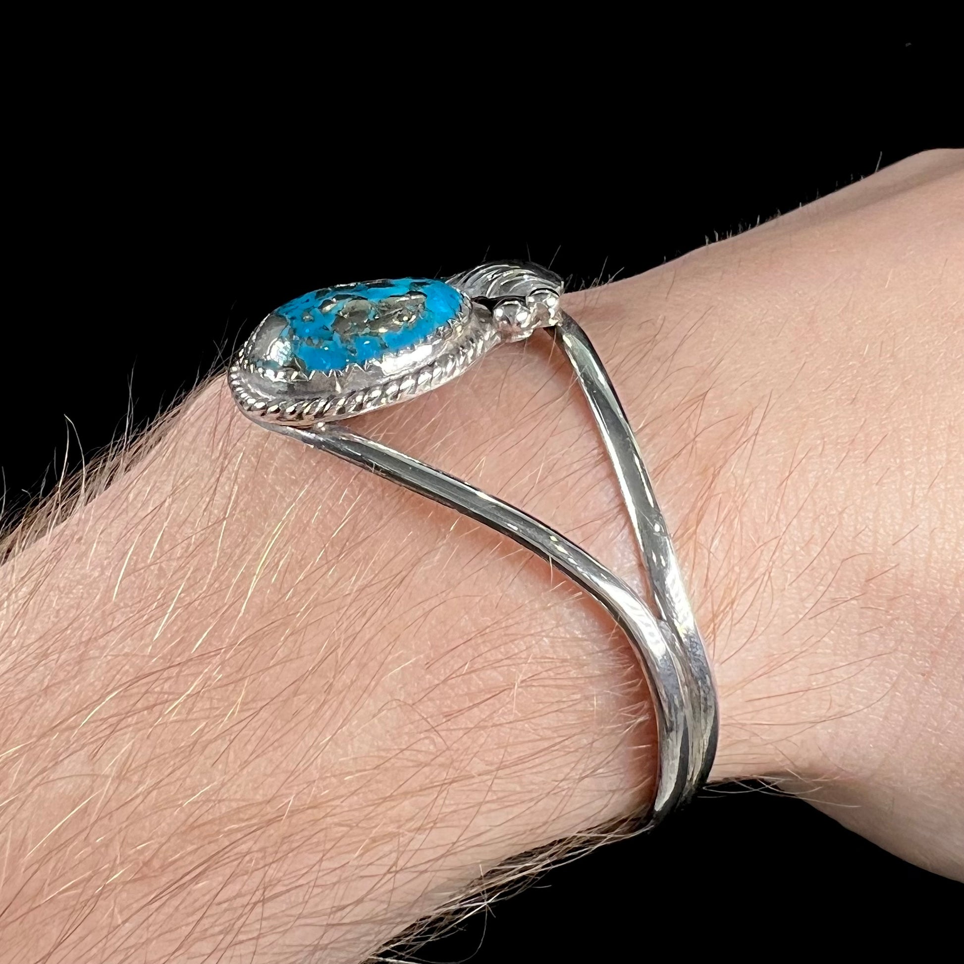 A ladies' silver Navajo cuff bracelet set with a piece of Morenci turquoise stone.