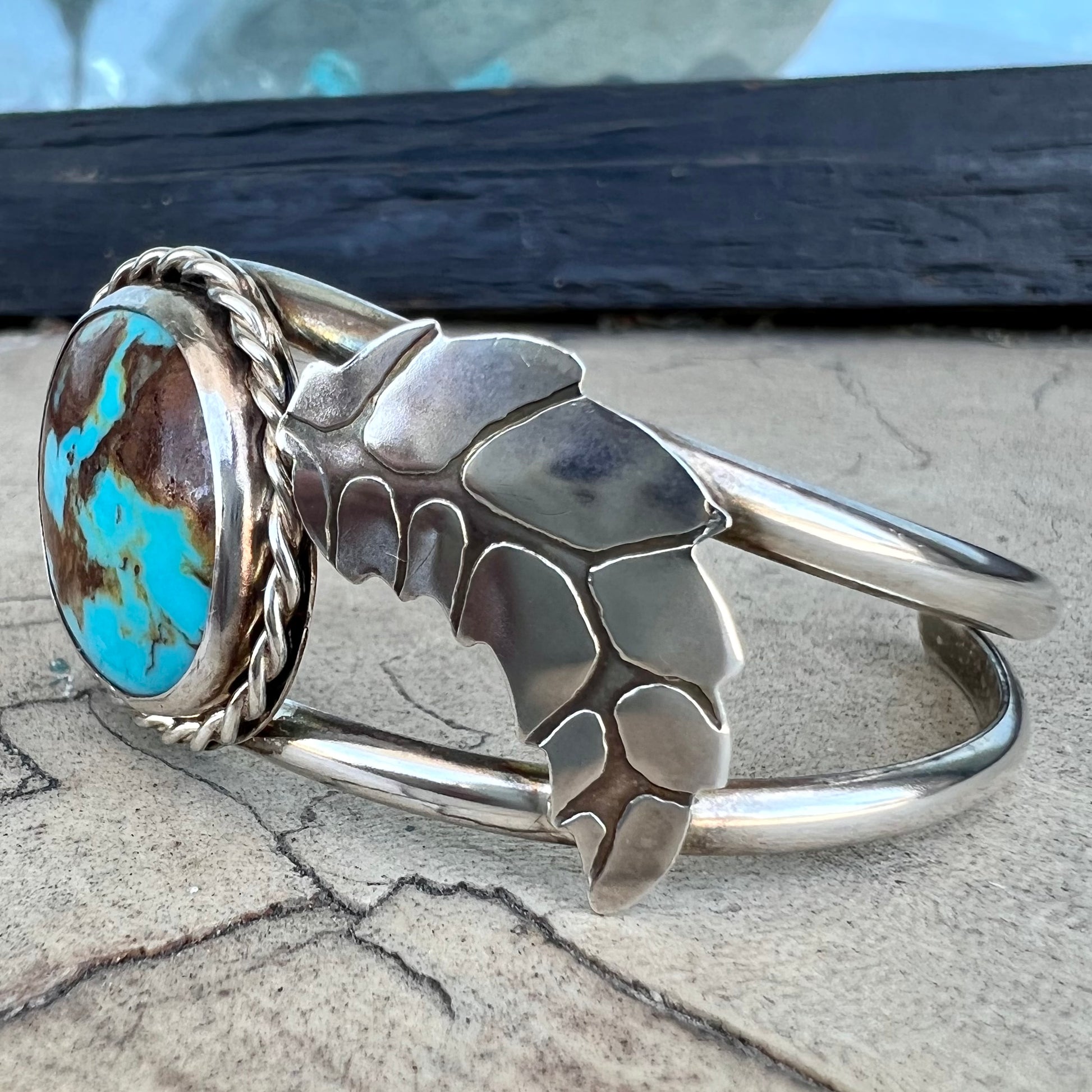 A sterling silver Navajo cuff bracelet set with a Royston turquoise stone.