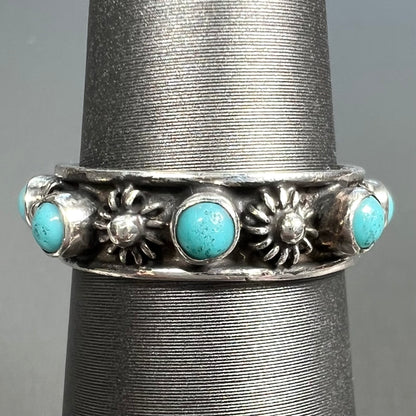 A sterling silver turquoise and flower design eternity band, made in Mexico.