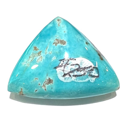 A loose triangular cabochon cut blue turquoise stone from the Sleeping Beauty Mine in Arizona.