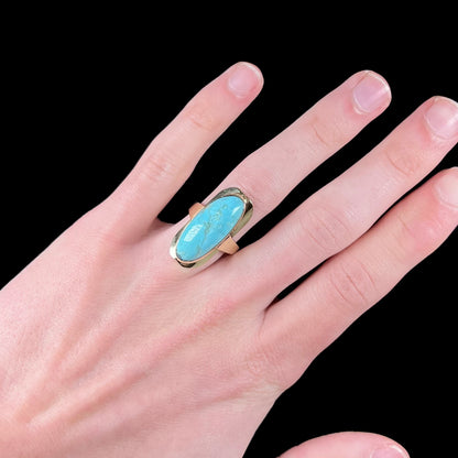 A Sleeping Beauty turquoise solitaire ring cast in 14kt yellow gold.