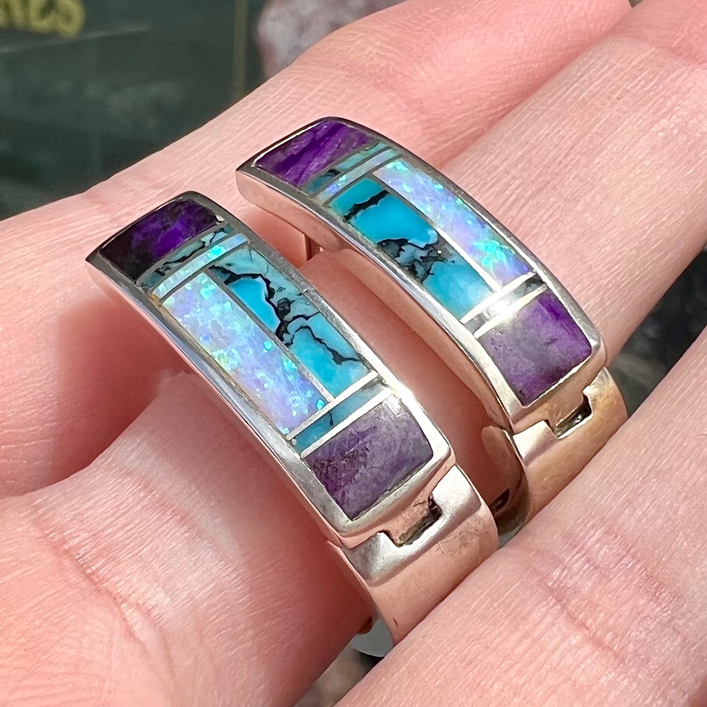 A pair sterling silver inlay earrings set with turquoise, sugilite, and lab created opal stones.