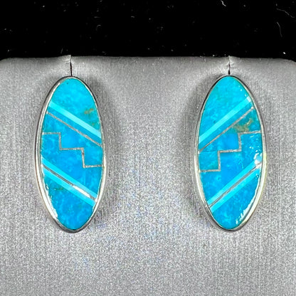 A pair of sterling silver turquoise inlay earrings, handmade by the Zuni artist.