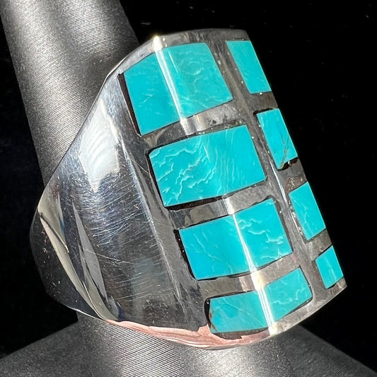 A men's sterling silver turquoise inlay ring, circa 1970.  The piece is set with 8 stones.