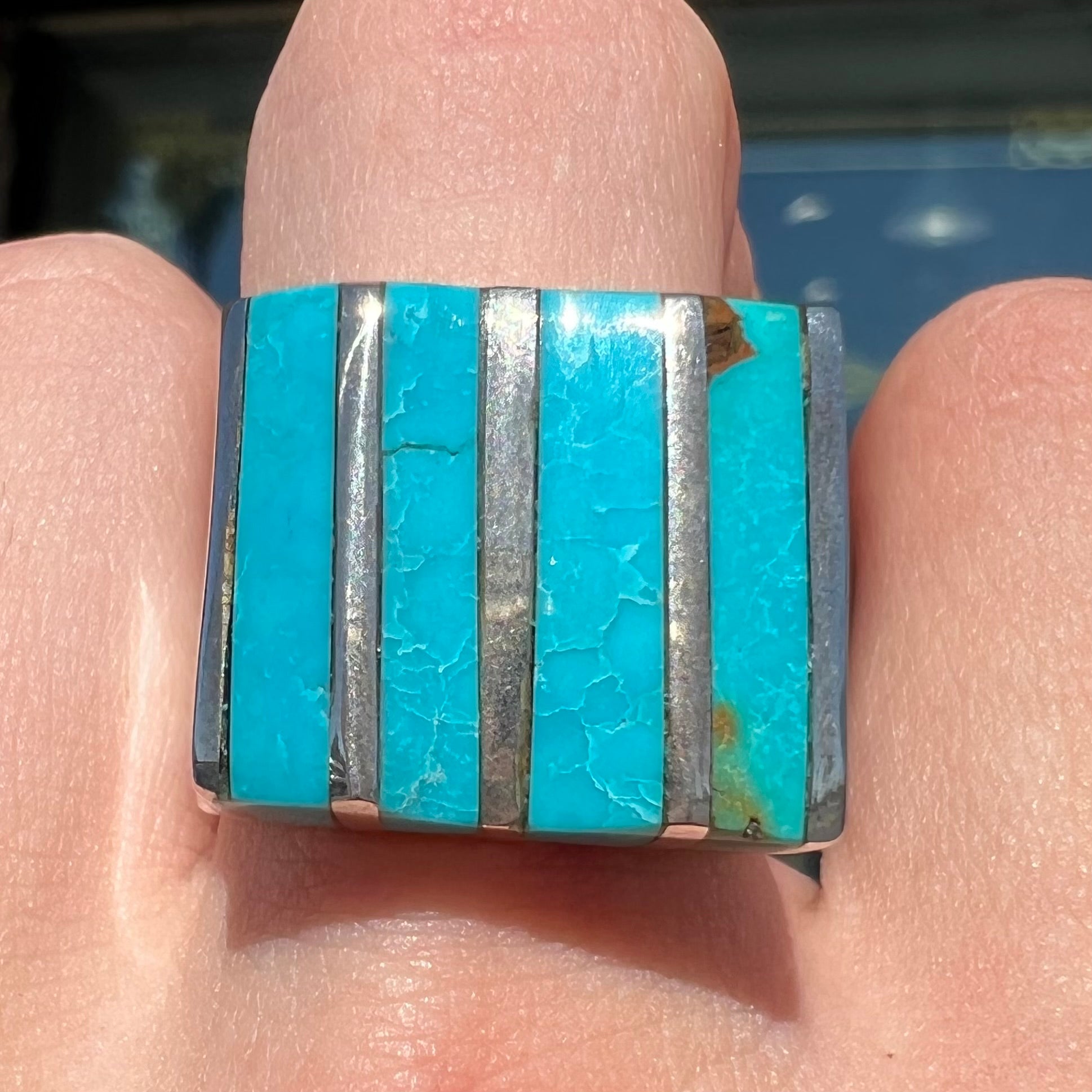 A men's turquoise ring inlay set with four turquoise stones.