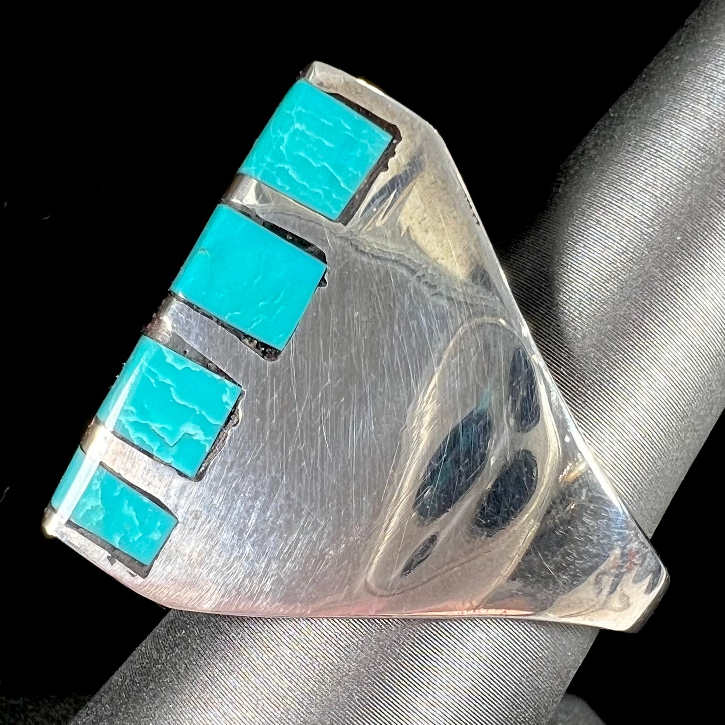 A men's sterling silver turquoise inlay ring, circa 1970.  The piece is set with 8 stones.