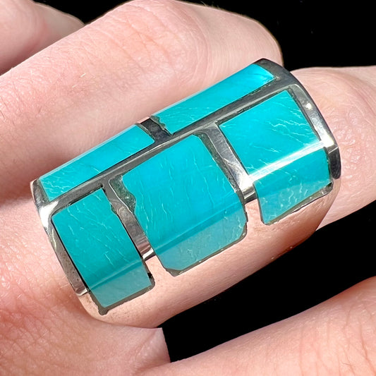 A sterling silver men's ring inlaid with five Royston turquoise stones.