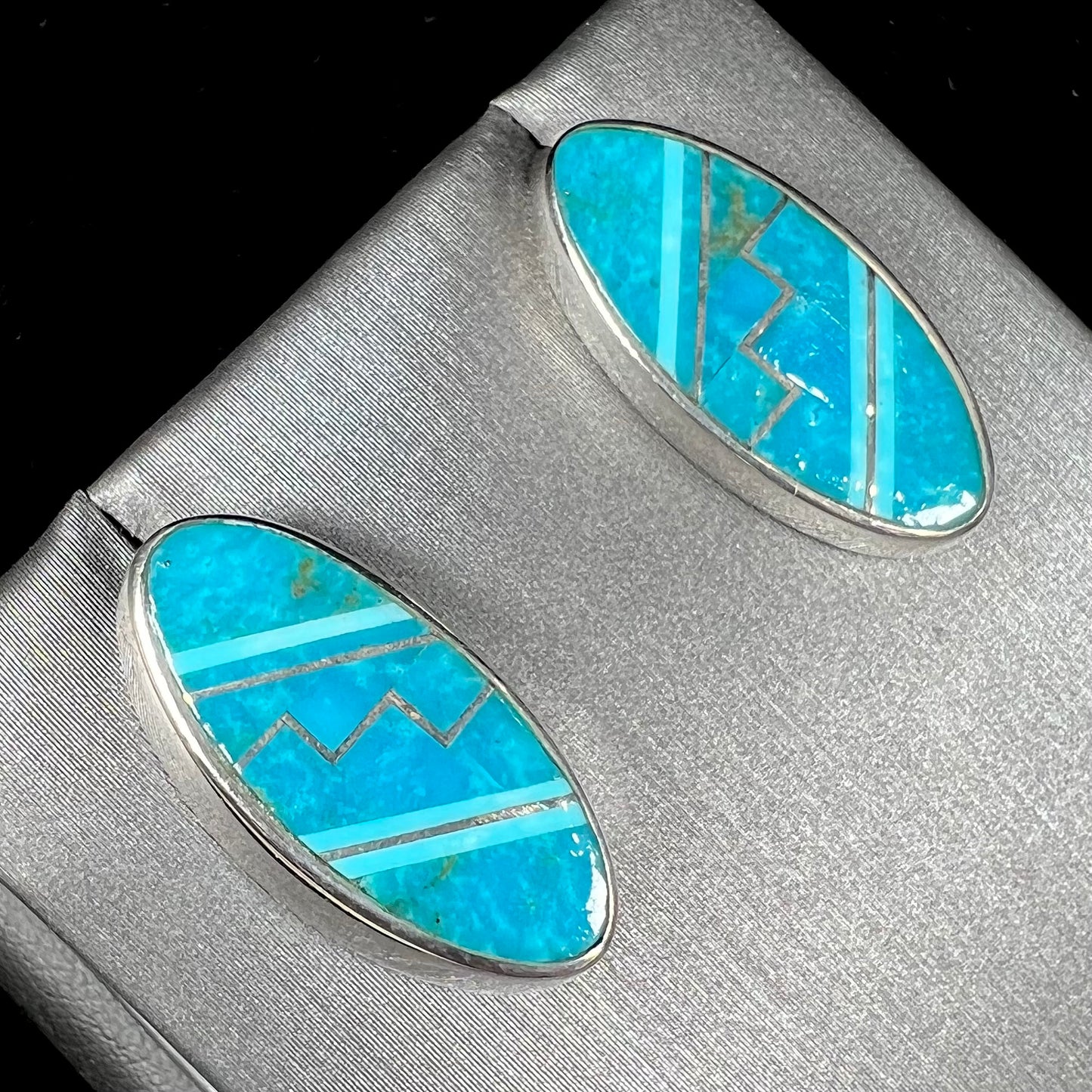 A pair of sterling silver turquoise inlay earrings, handmade by the Zuni artist.