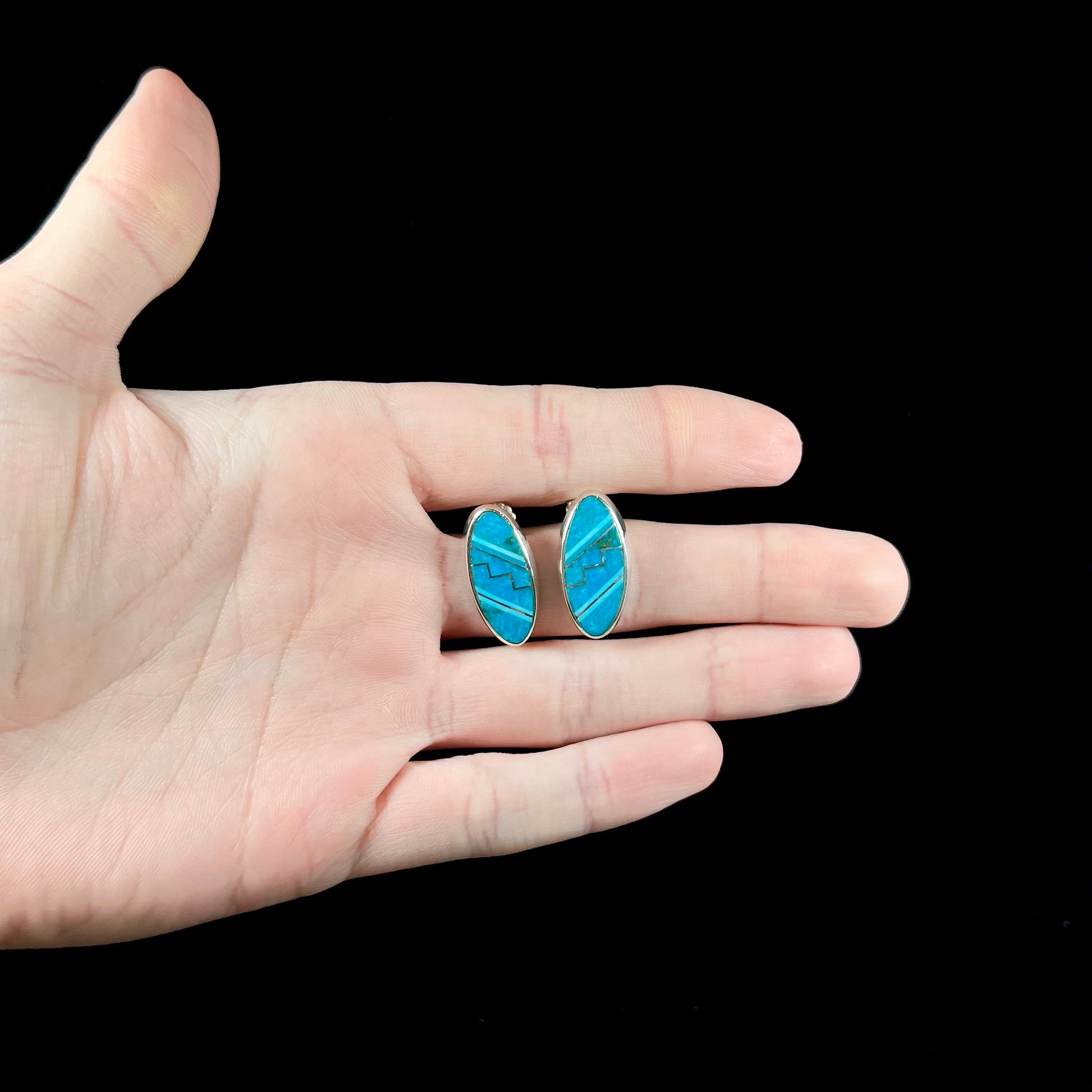 A pair of sterling silver turquoise inlay earrings, handmade by the Zuni artist.