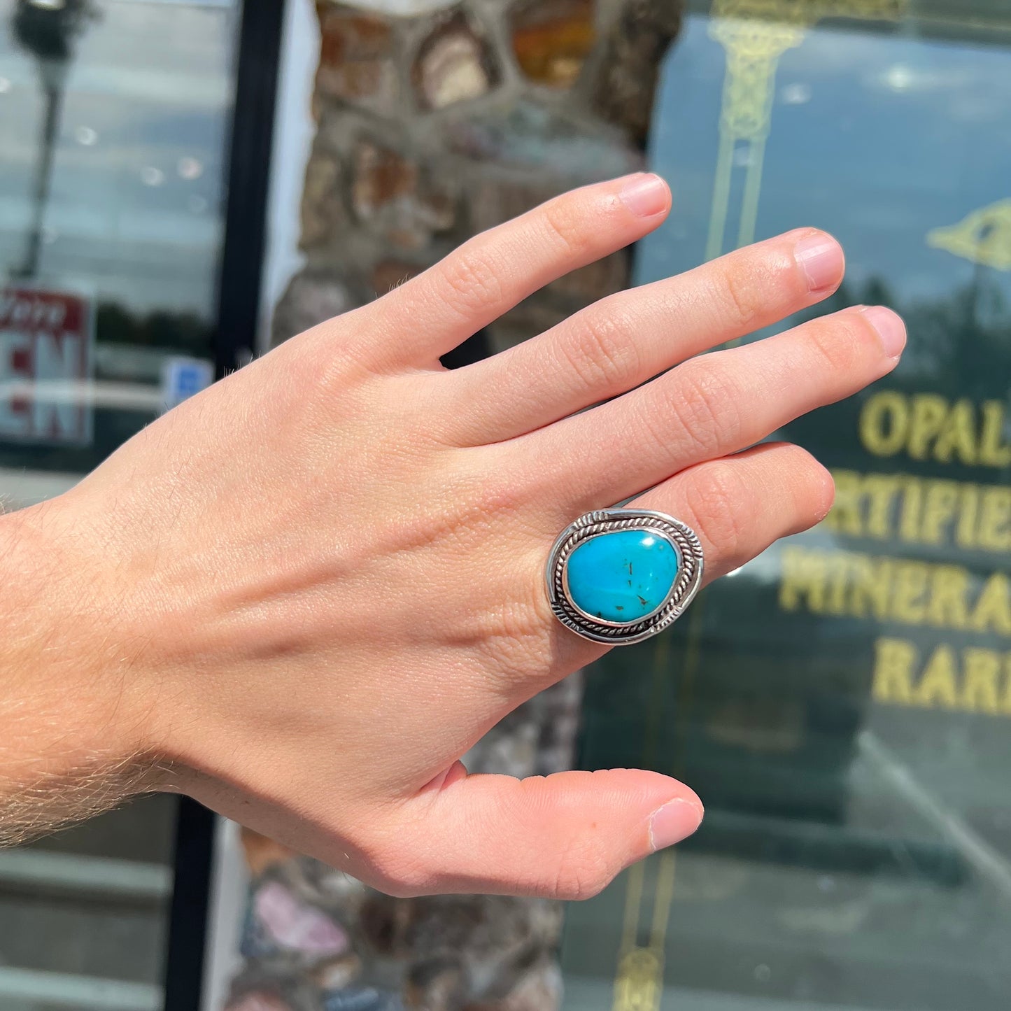 A men's silver, handmade, Navajo turquoise ring.