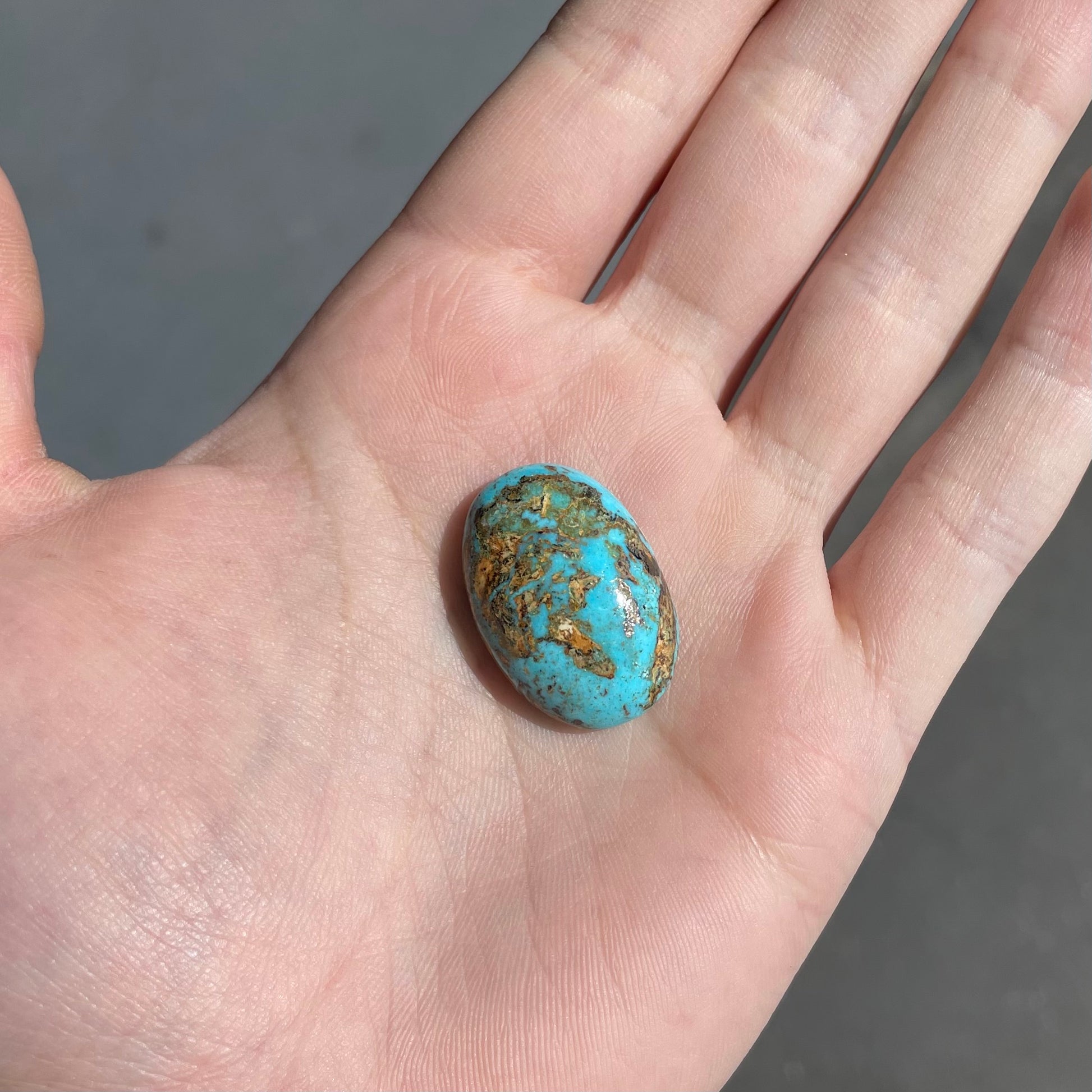 A loose, oval cabochon cut turquoise stone from Sonora, Mexicao.