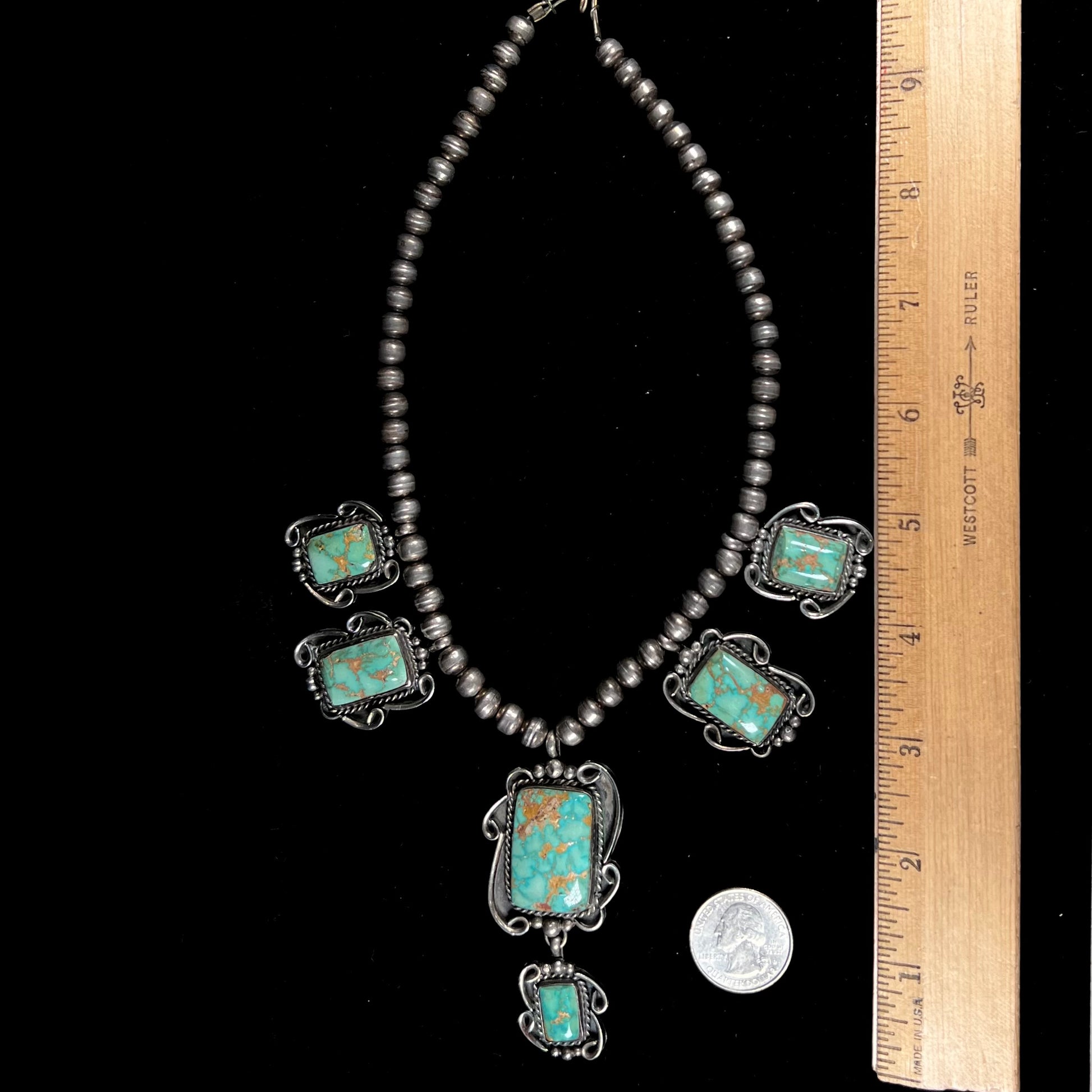 A sterling silver Navajo turquoise necklace set with Pilot Mountain Mine turquoise stones by artist Minnie Thomas.