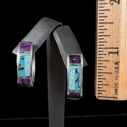 A pair sterling silver inlay earrings set with turquoise, sugilite, and lab created opal stones.