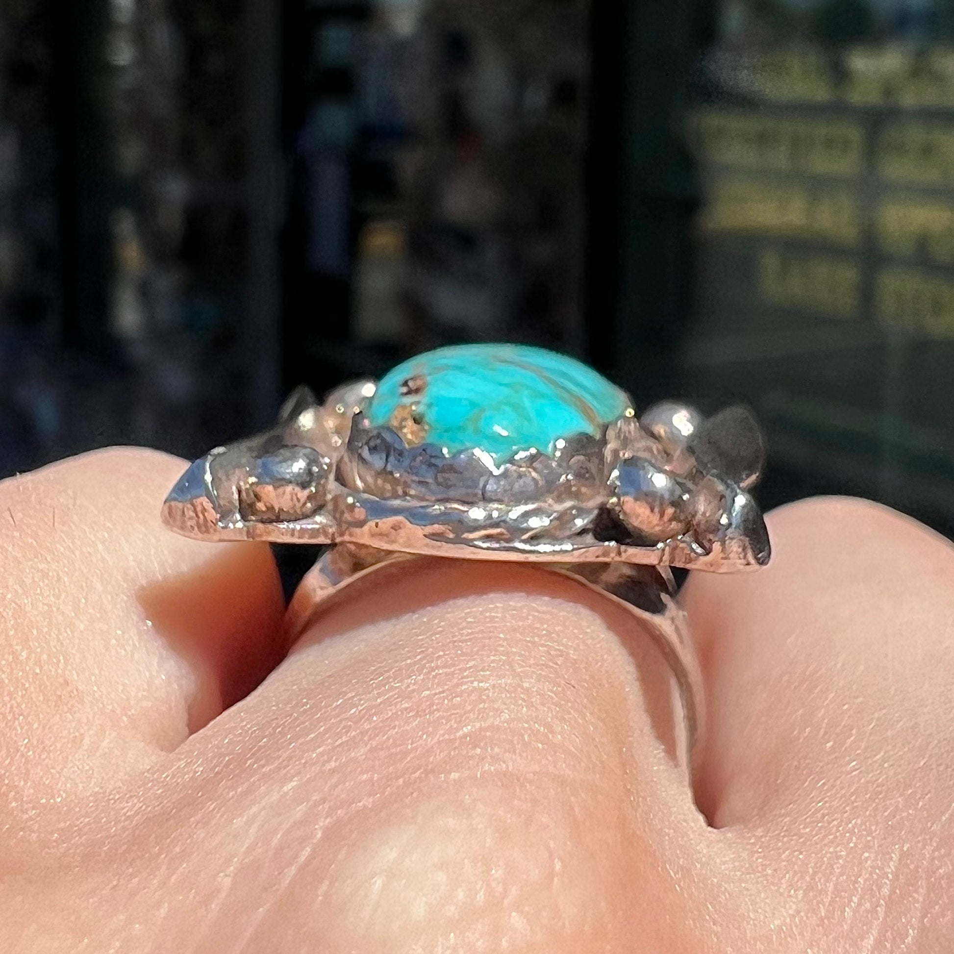A sterling silver ring set with Tyrone turquoise from Burro Mountains, New Mexico.