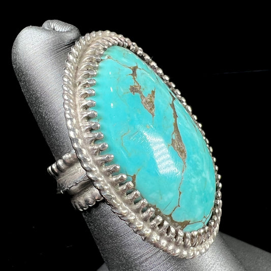 A sterling silver rope design ring set with a turquoise stone from Pilot Mountain Mine, Nevada.