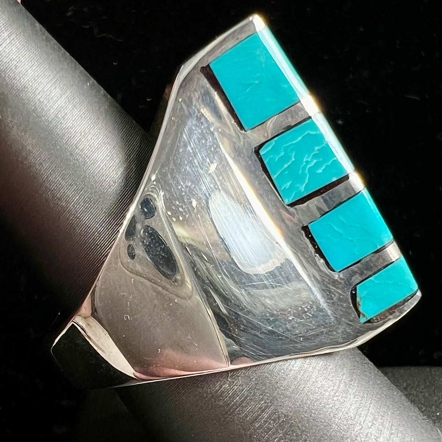 A men's sterling silver turquoise inlay ring, circa 1970.  The piece is set with 8 stones.