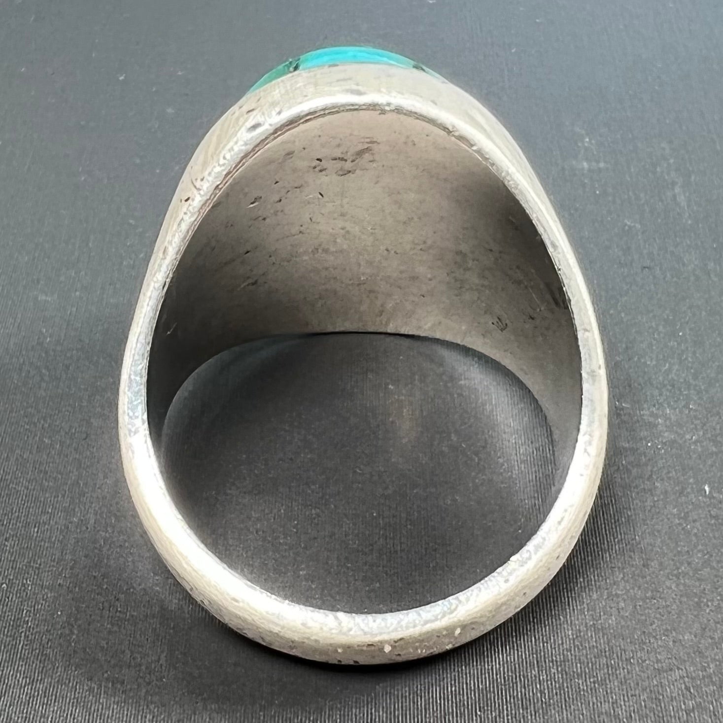 A men's textured silver turquoise solitaire ring.  The turquoise is from Royston Mining District, Nevada.