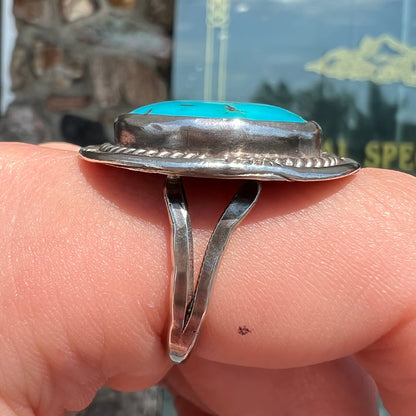 A men's silver, handmade, Navajo turquoise ring.