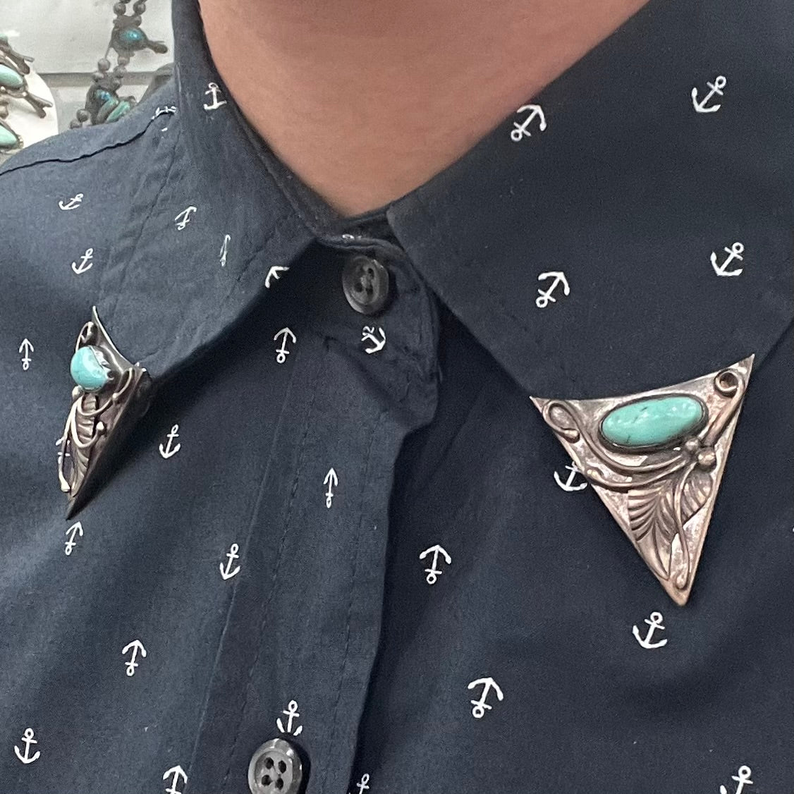 A pair of sterling silver and turquoise shirt collar tips handmade by Navajo artist, Phillip Guerro.
