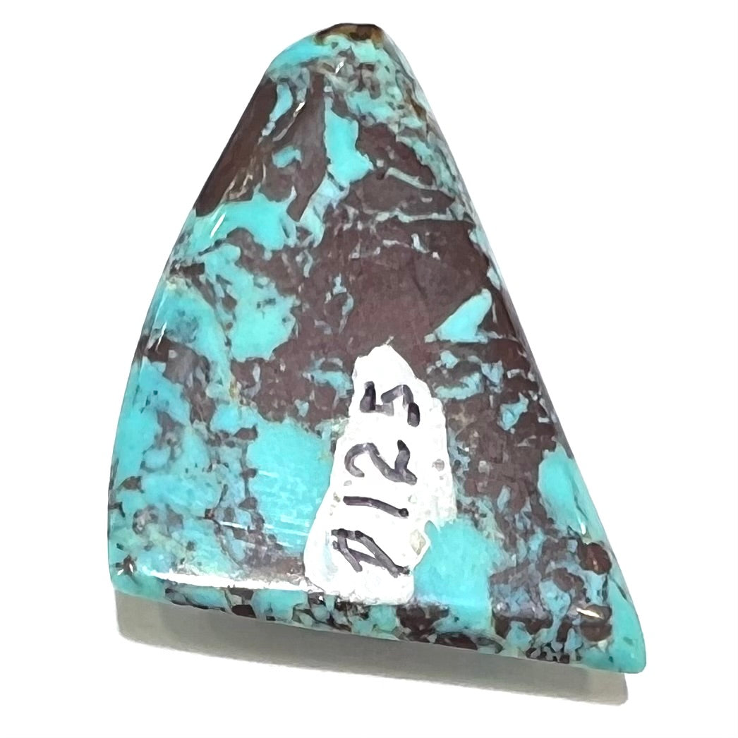A triangular cabochon cut blue turquoise with red matrix from Mohave County, Arizona.
