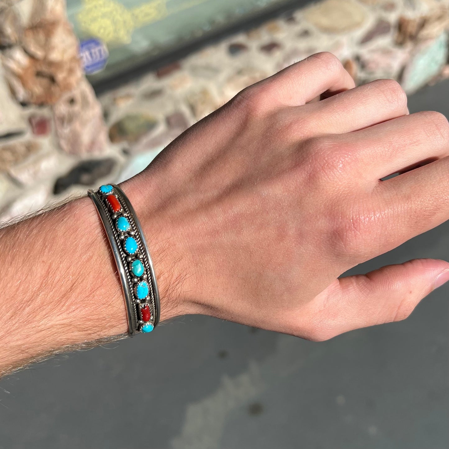A silver ladies' turquoise and coral cuff bracelet, handmade by Navajo artist, John Delvin.