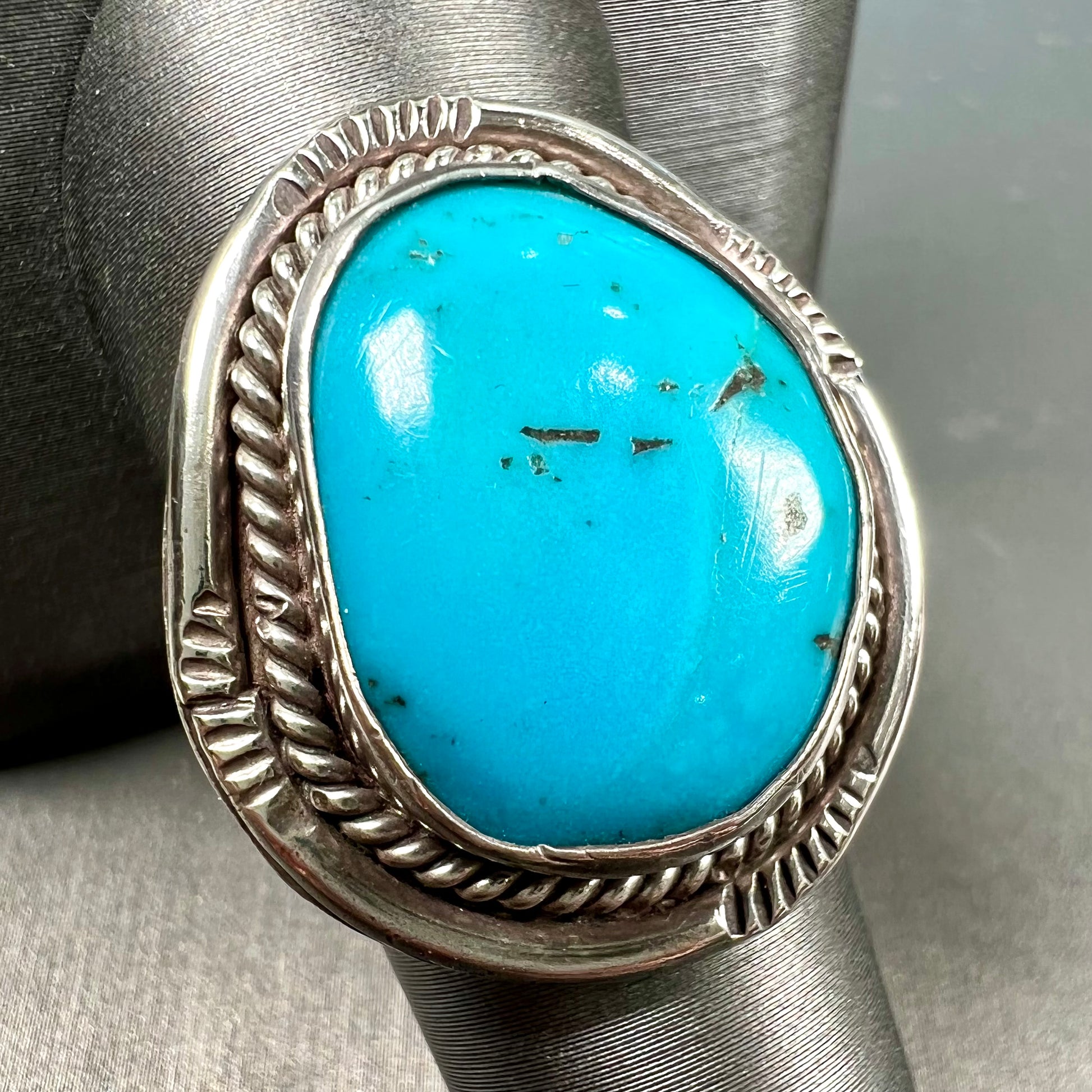 A men's silver, handmade, Navajo turquoise ring.