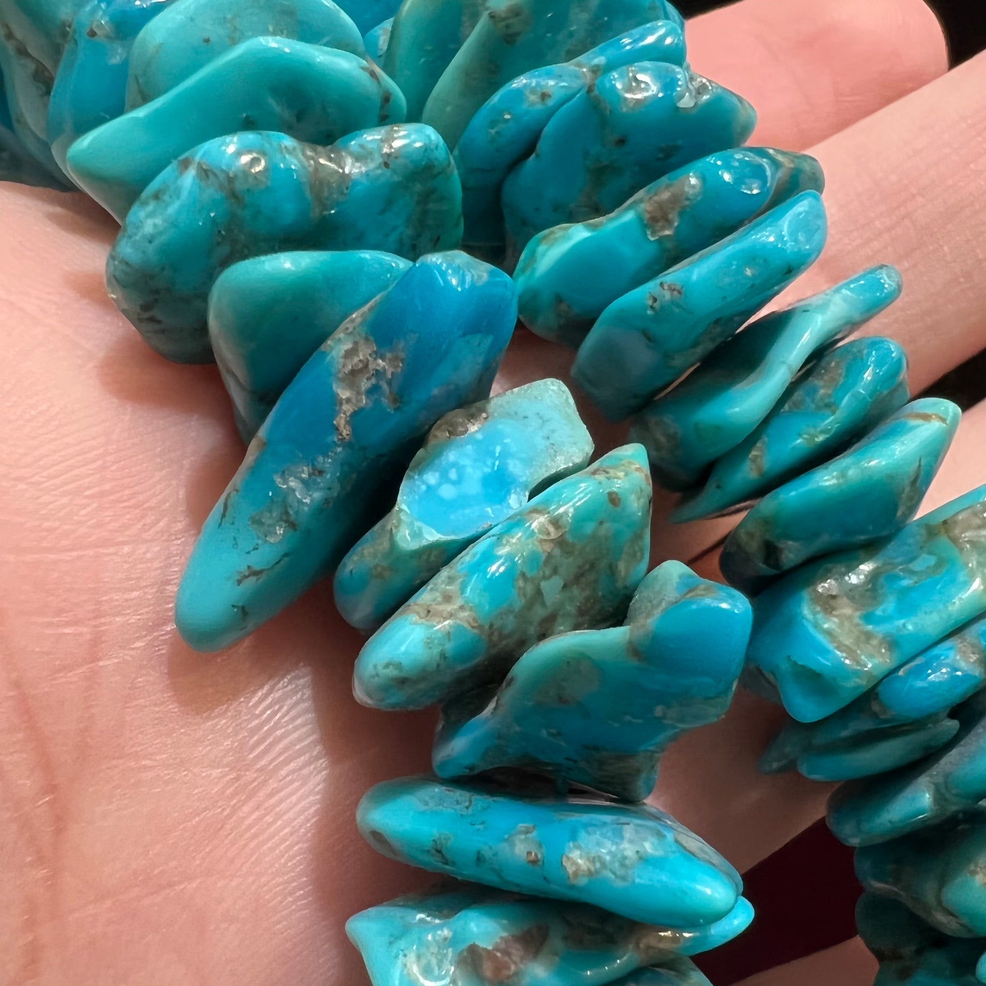 A men's turquoise stone bead necklace made from polished Kingman and Sleeping Beauty Mine turquoise.
