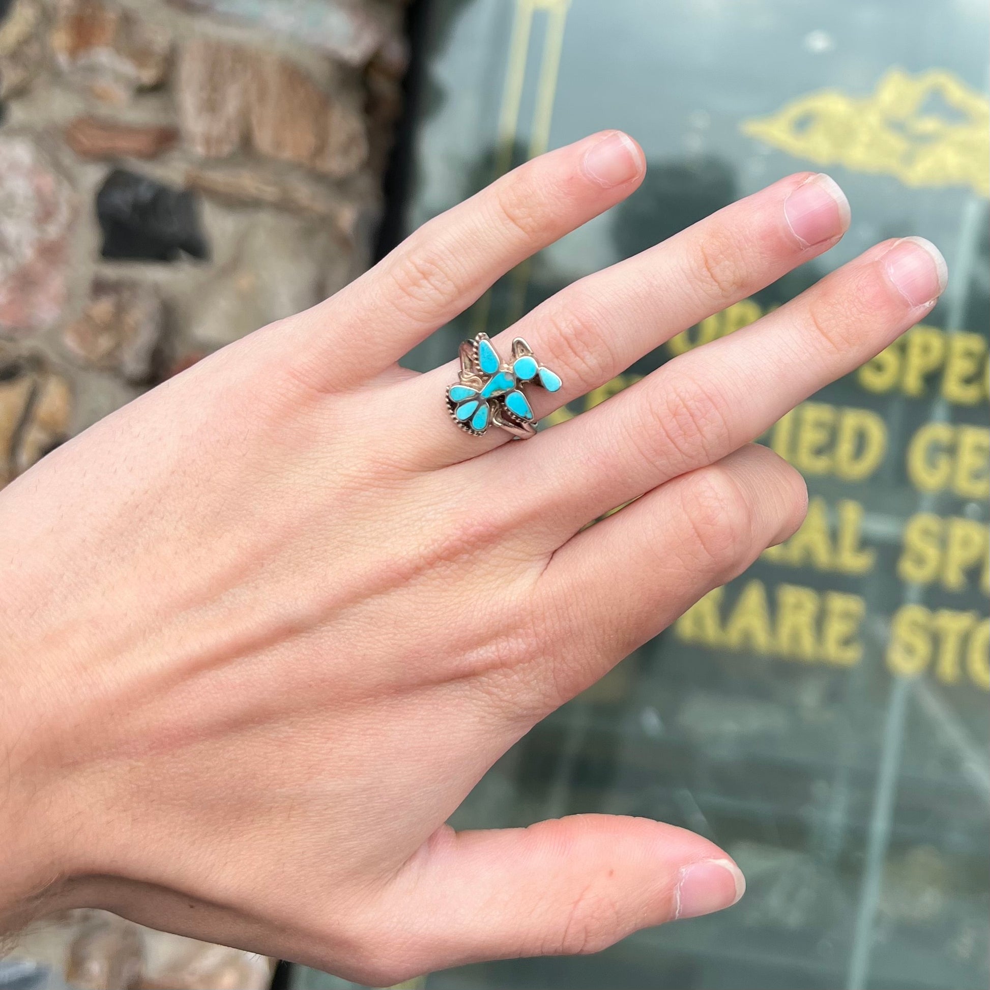 A sterling silver and turquoise inlay ring.  The ring is in the shape of a Native American thunderbird.