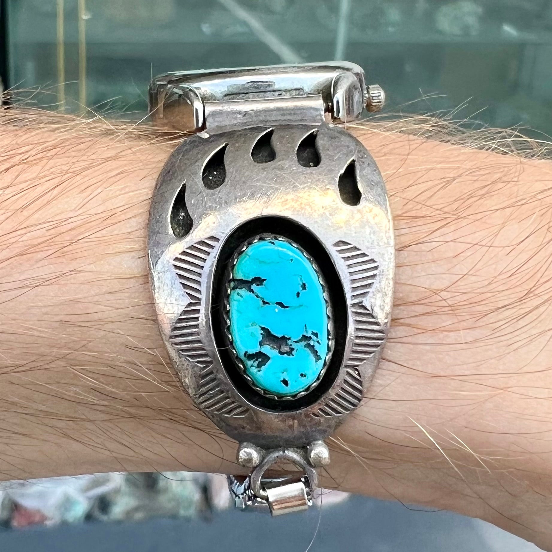 A watch set with two turquoise stones handmade by Navajo artists Arnold and Carleena Goodluck.