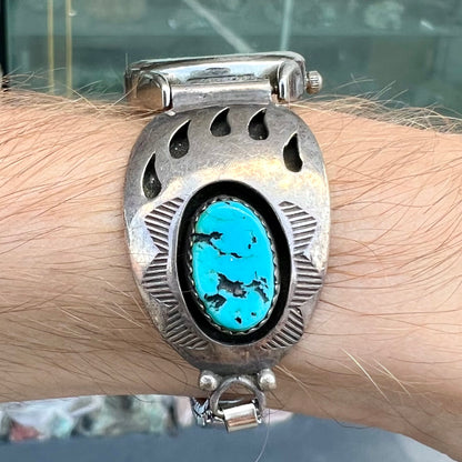A watch set with two turquoise stones handmade by Navajo artists Arnold and Carleena Goodluck.