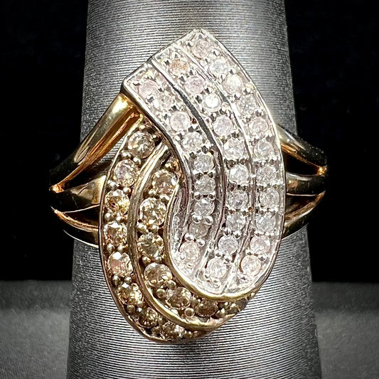 A ladies' 10 karat yellow gold split shank ring pave set with white and champagne colored diamonds.