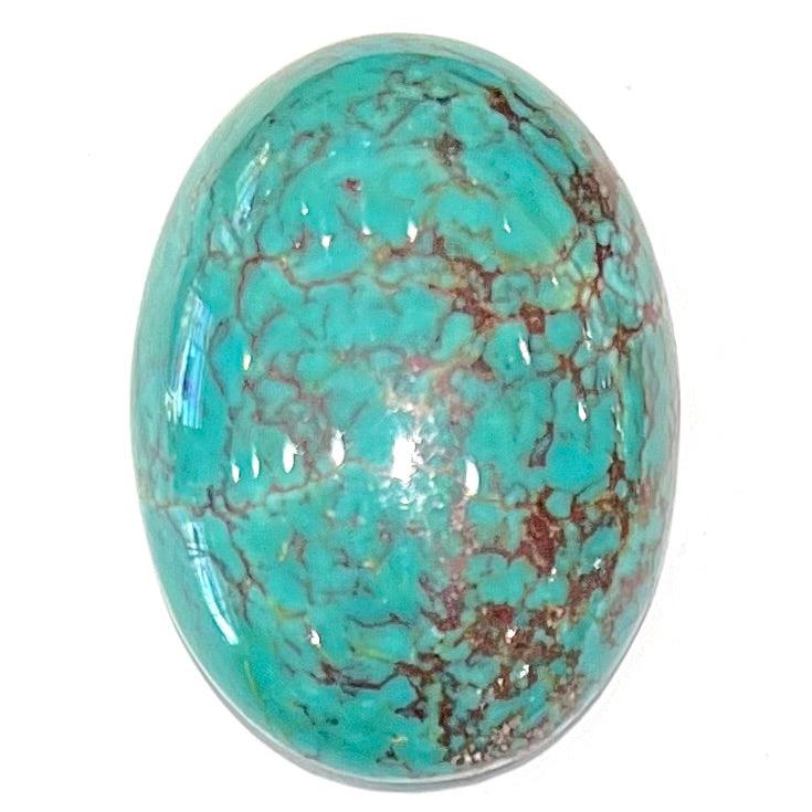 A loose, oval cabochon cut Tyrone turquoise stone.