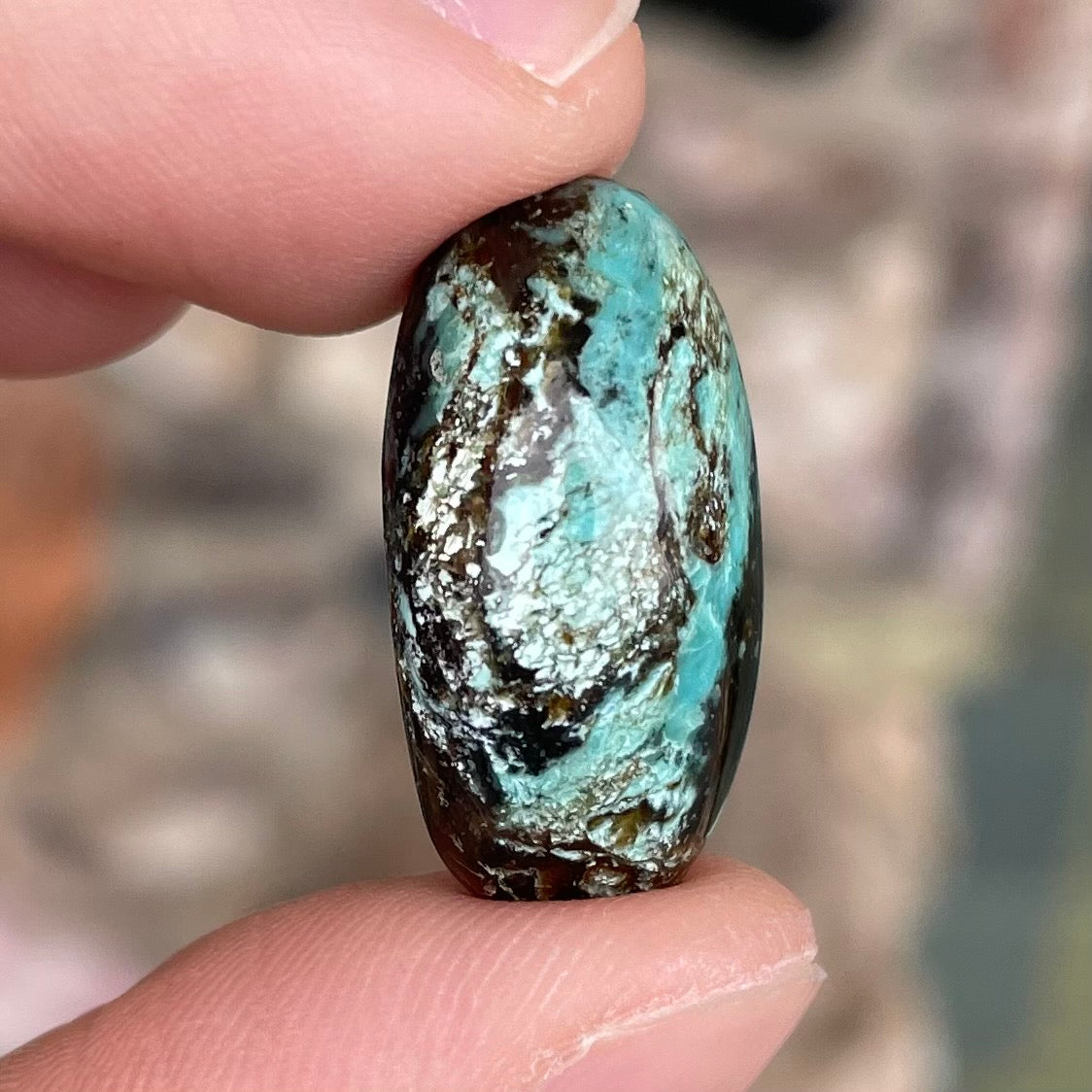 A loose, oval cabochon cut Royston turquoise stone from Nevada.