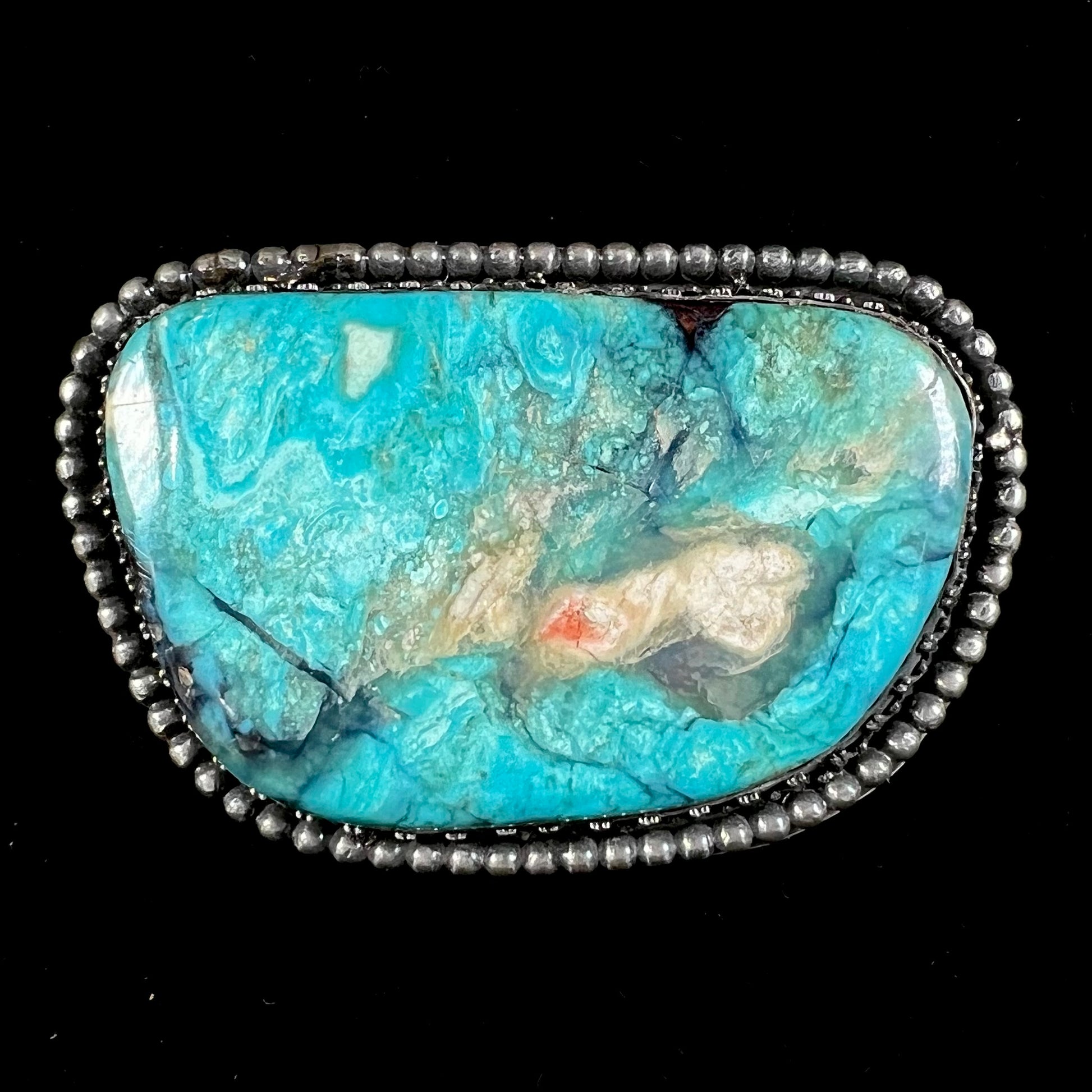 A sterling silver, unisex, Navajo style belt buckle set with a large Valley Blue turquoise stone.