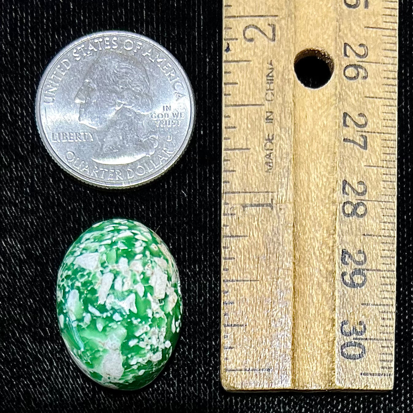 A loose green variscite cabochon from Utah, USA.