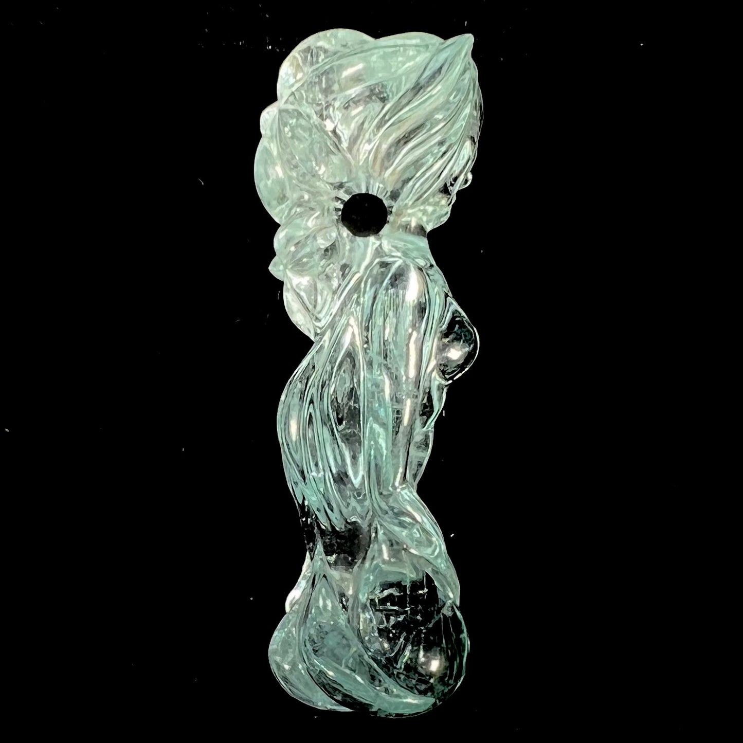 A stone woman figure carved from a blue aquamarine crystal.  The piece resembles Venus Gummi de Milo.