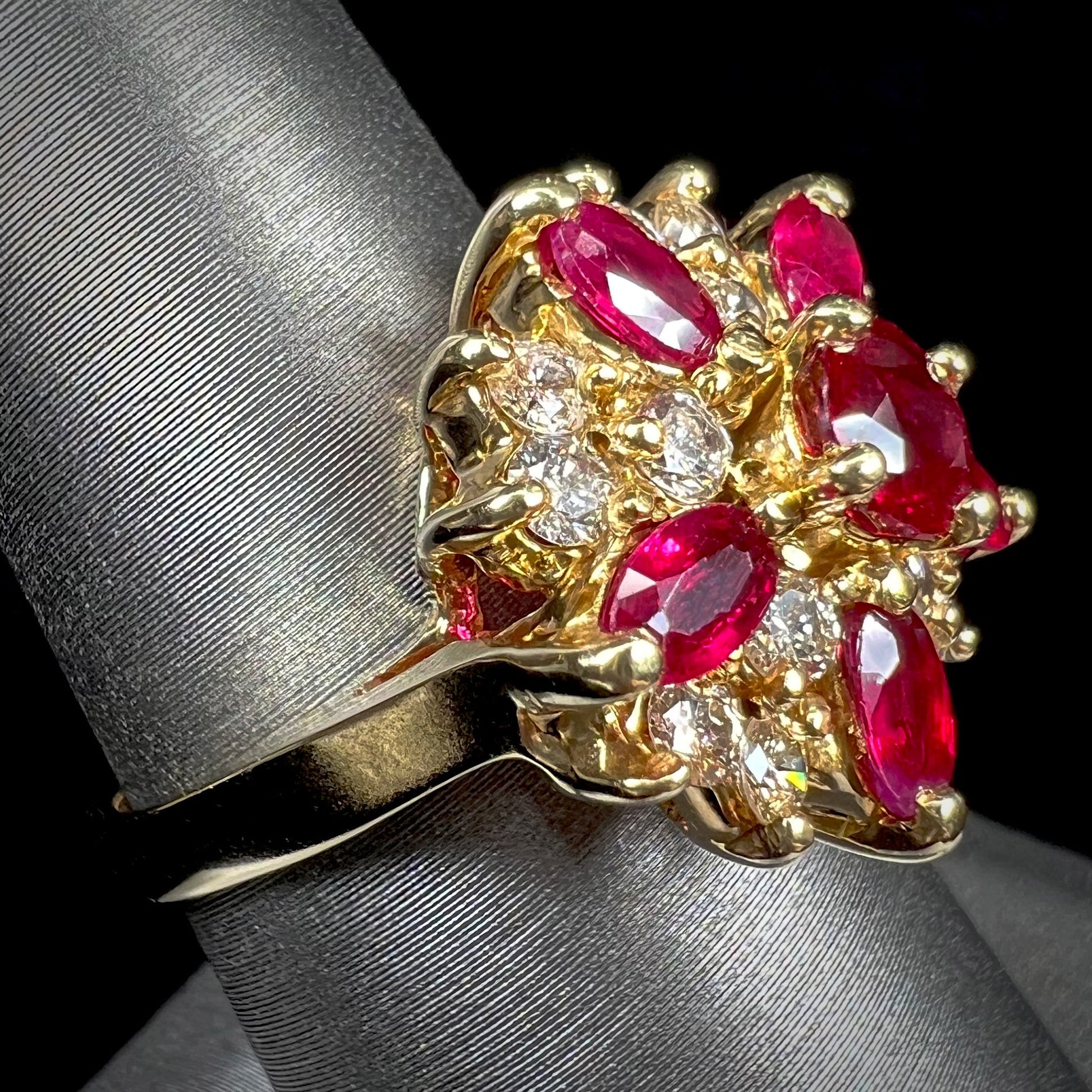 A ladies' vintage yellow gold cluster ring set with diamonds and pigeon blood red Burma rubies.