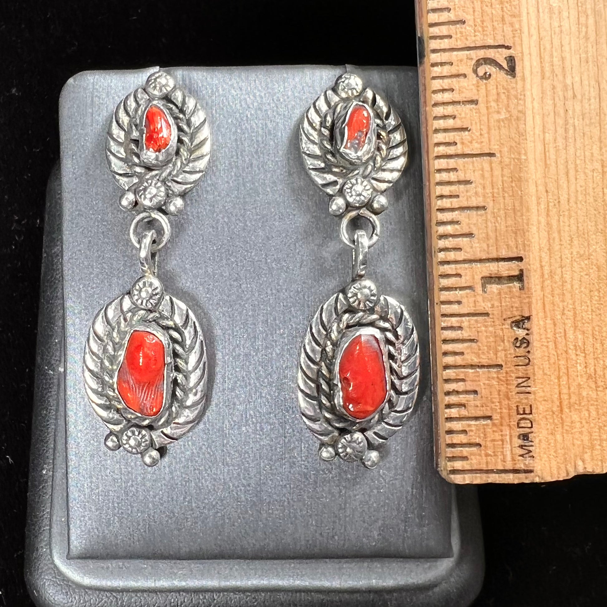 A pair of vintage coral branch dangle earrings handmade by Navajo artist, Delbert Chatter.