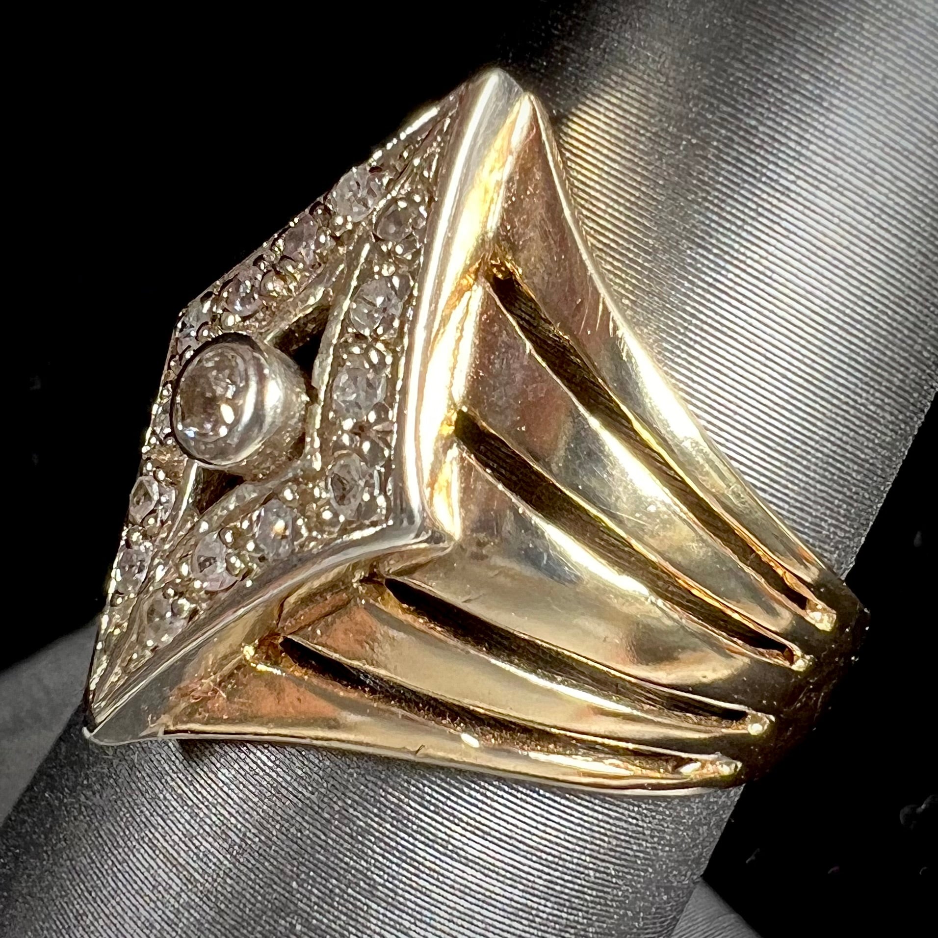 An estate ladies' gold diamond ring.  The shape of the ring resembles an art deco style diamond.